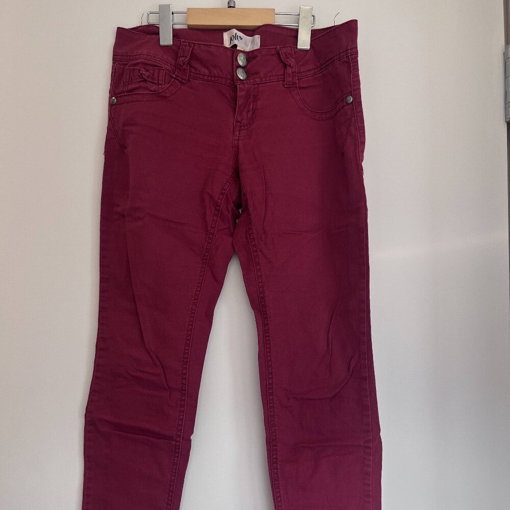 Jolt skinny jeans in a deep reddish or burgundy color